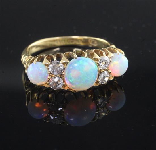 An Edwardian 18ct gold, white opal and diamond ring, size P.